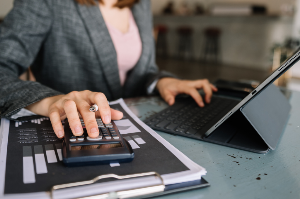 Professional reviewing financial data and using a tablet, representing the analytical approach of Burton Ratings Services.